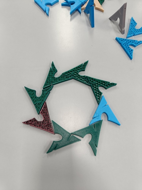 3D-printed Arch logos laid out in a way that resembles the NixOS logo