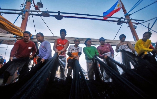 Fishermen who joined the second Atin Ito-led civilian mission to Scarborough Shoal catch fish within the Philippines' exclusive economic zone on Thursday, May 16, 2024. Atin Ito, which is challenging China's claim in the West Philippine Sea, said they are not intimidated by the growing number of Chinese vessels in the area. DANNY PATA
