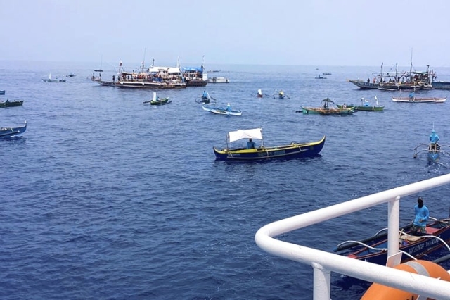 In this photo provided by the Philippine Coast Guard, fishing boats carrying activists and volunteers belonging to a nongovernment coalition called Atin Ito, Tagalog for This is Ours, pass by waters off Palauig Point, Zambales province, northwestern Philippines as they head towards Scarborough Shoal on Wednesday May 15, 2024. A flotilla of about 100 mostly small fishing boats led by Filipino activists sailed Wednesday to a disputed shoal in the South China Sea, where Beijing's coast guard and suspected militia ships have used powerful water cannons to ward off what they regard as intruders. (Philippine Coast Guard via AP)