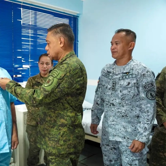 COMMANDER ON LEAVE. Vice Admiral Alberto Carlos (right-most) looks on as AFP chief General Romeo Brawner Jr. awards one of the soldiers who was injured during a March 2024 resupply mission to the BRP Sierra Madre.