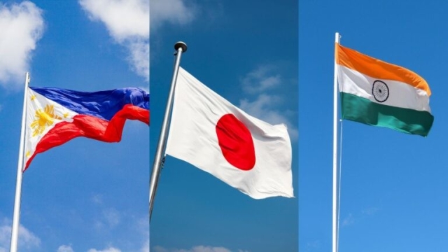 The flags of the Philippines, Japan and India wave in the wind in a composite picture.