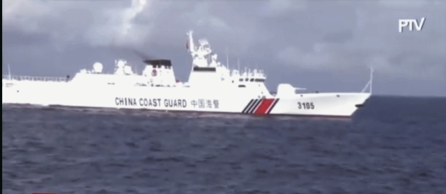 A large Chinese coast guard ship blocking the BRP Datu Sanday from resupplying Filipino fishermen at Bajo de Masinloc