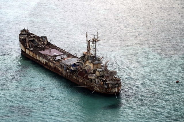 This aerial photograph taken from a military aircraft shows the dilapidated Sierra Madre ship of the Philippine Navy anchored near Ayungin shoal (Second Thomas Shoal) with Philippine soldiers on-board to secure the perimeter in the Spratly group of islands in the South China Sea, west of Palawan, on May 11, 2015. The Spratlys are considered a potential Asian flashpoint, and claimant nations including the Philippines have expressed alarm as China has embarked on massive reclamation activity. Ritchie B. Tongo, Pool/AFP