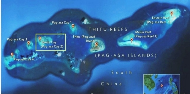 A map showing Pagasa Island ( Thitu) and the surrounding reefs. The Sandy Cay reef is highlighted by a rectangular box 