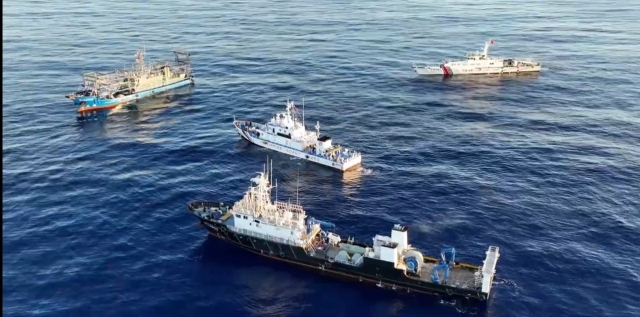 A 44 meter Philippine Coast Guard ship is surrounded by 2 Chinese militia shops and a Chinese Coast Guard vessel 