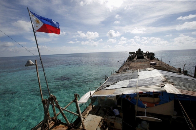 SOUTH CHINA SEA. This file photo shows a Philippine flag on top of the grounded BRP Sierra Madre at the Ayungin Shoal on March 29, 2014. 