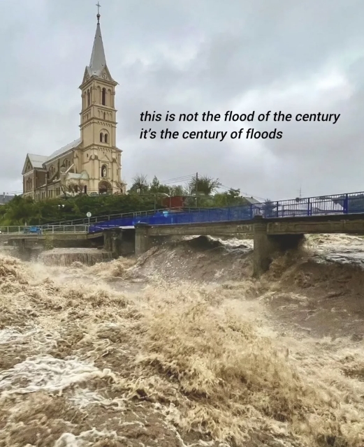 A torrent of water flows along the Bela River during heavy rain in Mikulovice, Czech Republic. Overlaid caption says: "This is not the flood of the century. It's the century of floods."