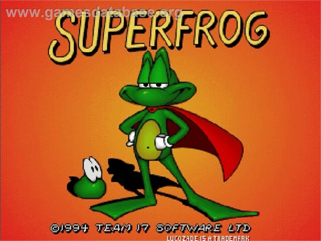 The image features the title screen for the video game "Superfrog," showcasing a cartoon frog character wearing a red cape and striking a confident pose against an orange background. A smaller green character is positioned beside the frog. The game's release year 1994