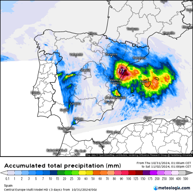 A map of spain indicating the accumulated total precipitation for the period october 31 noon to november 2nd noon. At the bottom you see the colorscale ranging from white over blue to green, orange, red, purple and grey. On the map you see a streak of blue indicating 1 to 10 mm of rain from the south tip  of spain and along the border with Portugal. Right above Valencia there's a zone where the color goes in concentric circles from blue on the outside to purple on the inside. It also shows a maximum estimated rainfall of 177 mm in the mountains north of Valencia right next to the coast. 