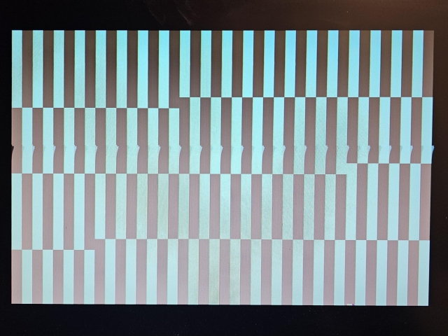 Picture of a scrambled screen image from a failed Amstrad COC 464. It shows alternating black and cyan vertical bars. 