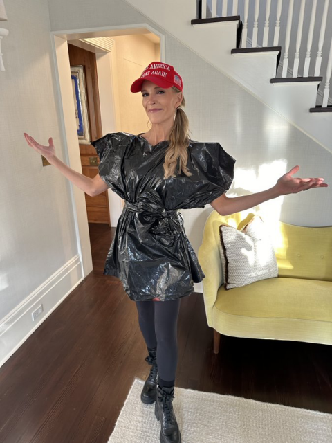 Megyn Kelly, arms outstretched, wearing a MAGA hat and a dress made out of garbage bags.