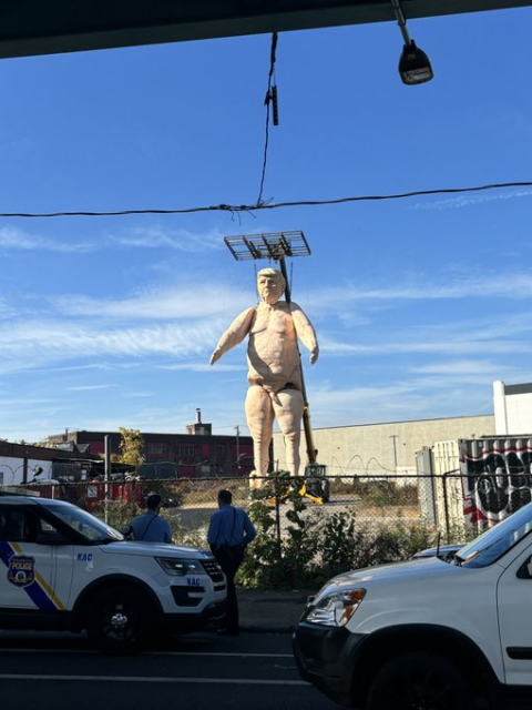 Huge lumpy, makeshift statue of a blubbery, naked Donald Trump.