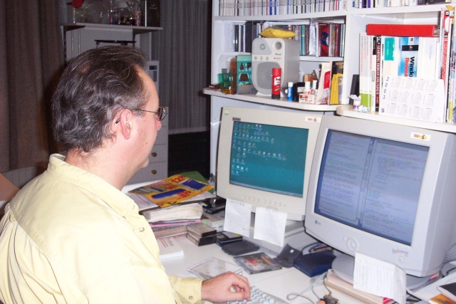 Bram coding on VIM in front of his computers