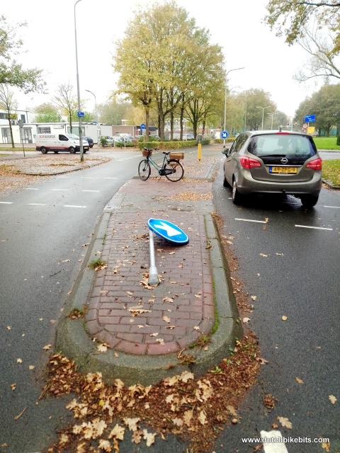 On the way home parked on a central divider where cyclists and pedestrians cross the road. A driver has lost control here and run straight over the "safe" place for us, demolishing a sign on the way.