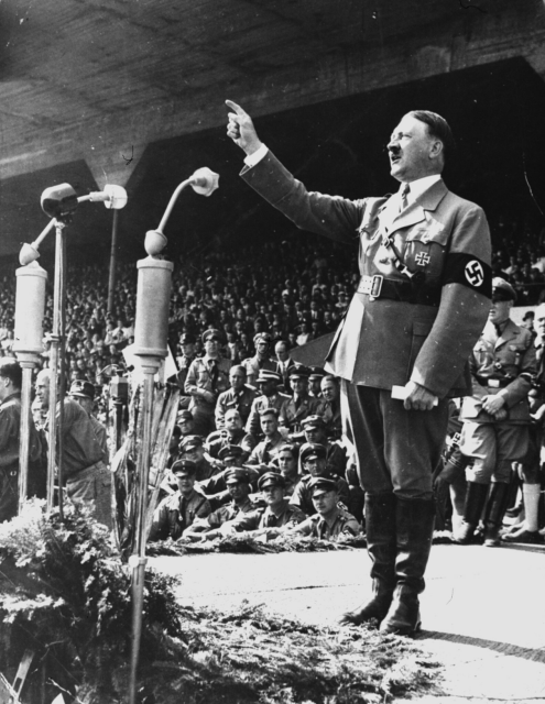 Adolf Hitler holding a speech at a Nazi rally.