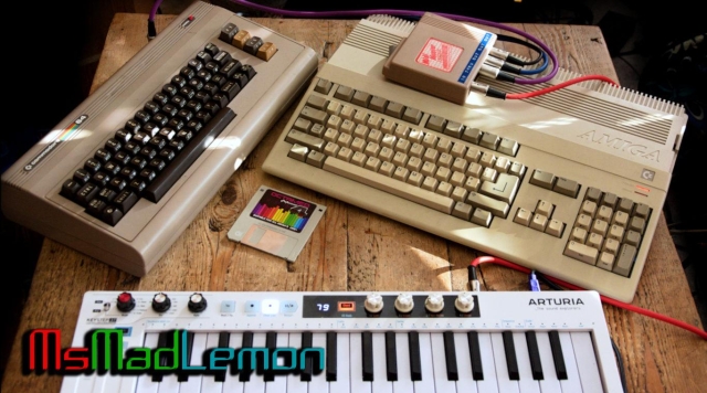 An original Amiga 500 and commodore 64 breadbin side by side while connected together via a Datel MIDI interface and the Mssiah cartridge on the C64. There's also an arturia MIDI controller. 