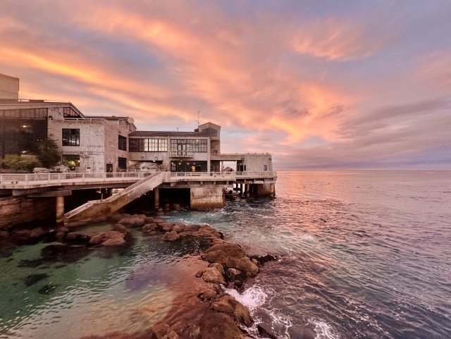 A photo of Monterey bay Aquarium and a beautiful sunset 