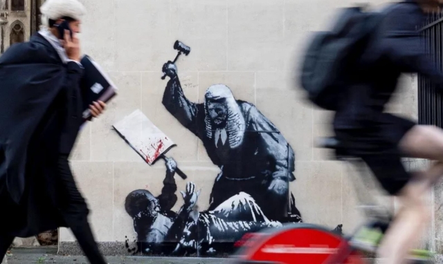 Banksy image of judge beating protestor