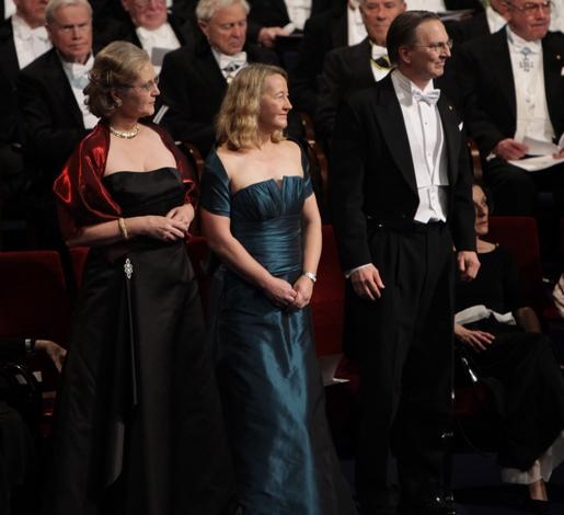 Elizabeth H. Blackburn, Carol W. Greider and Jack W. Szostak at the ceremony. They are all white people in evening wear. 