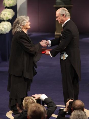 Ada E. Yonath accepting her Nobel medal. She is a white woman with grey hair.