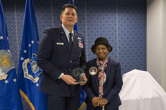 Air Force Space Command Vice Commander Lt. Gen. DT Thompson delivers presents Dr. Gladys West with an award as she is inducted into the Air Force Space and Missile Pioneers Hall of Fame during a ceremony in her honor at the Pentagon in Washington, D.C., Dec. 6, 2018. 

West was among the so-called "Hidden Figures" part of the team who did computing for the U.S. military in the era before electronic systems. The Air Force Space and Missile Pioneers Hall of Fame is one of Air Force's Space Commands Highest Honors.(Photo by Adrian Cadiz)

The image shows Lt. Gen. DT Thompson, Vice Commander of Air Force Space Command, presenting Dr. West with her award. Dr. West appears dignified and elegant.

https://en.wikipedia.org/wiki/Global_Positioning_System#/media/File:181206-F-DT527-136.jpg
