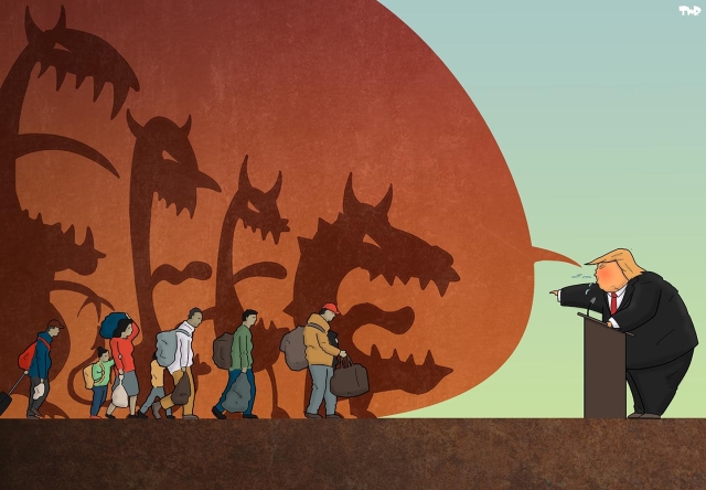 Cartoon showing a line of migrants walking. Trump is giving a speech; a giant speech bubble is extending behind the walking migrants, giving each of them a large shadow in the form of a demon with horns and sharp teeth.