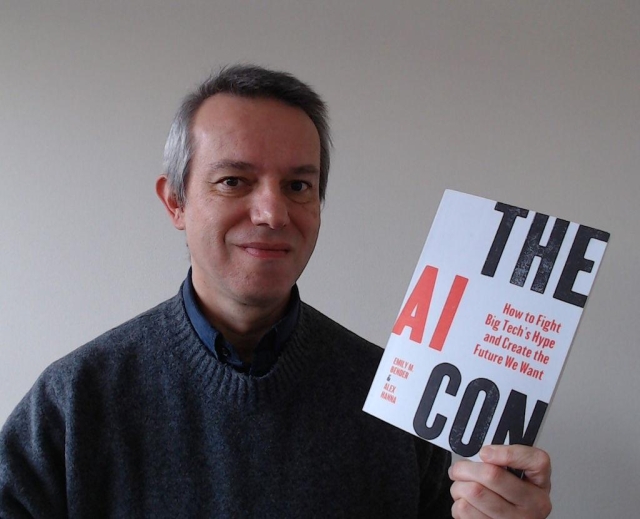 A selfie of me holding the book "the AI Con" by Emily M. Bender and Alex Hanna.