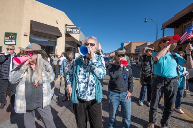 Singers using brightly colored paper megaphones. 