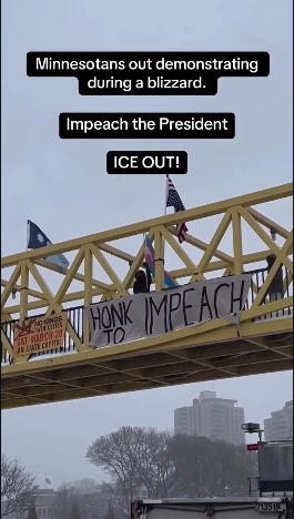 People on a yellow pedestrian bridge over a highway are protesting in bitter cold and snow with a US flag of distress, a Minnesota stage flag, a banner advertising the No Kings march on March 28th, and a banner that says "HONK TO IMPEACH"

Text boxes says "Minnesotans out demonstrating during a blizzard. Impeach the President! ICE OUT!"